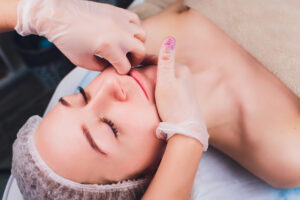 Image of a woman receiving a soothing face massage as part of holistic treatments for TMJ (Temporomandibular Joint Disorder), promoting relaxation and relief from tension.